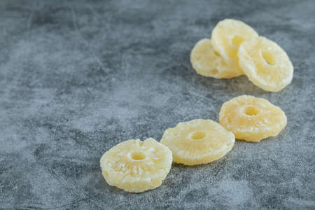 Dried pineapple slices on a gray backgroundの写真素材