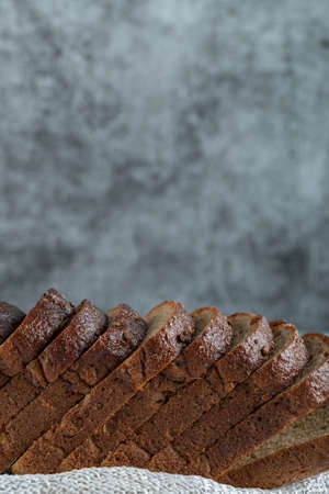 A wooden cutting board with slices of breadの写真素材