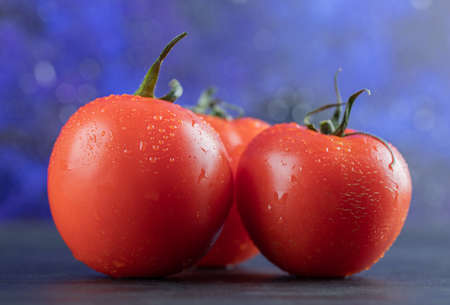 Some of fresh tomatoes on a dark background