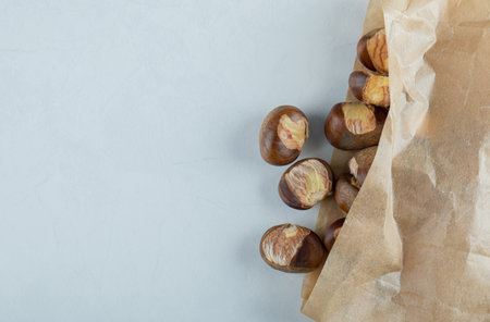Delicious healthy chestnuts on a tree barkの写真素材