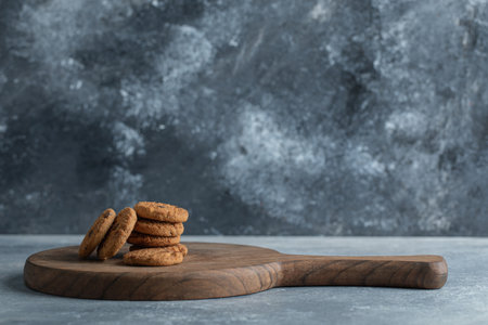 Stack of chocolate chip cookies on wooden boardの写真素材