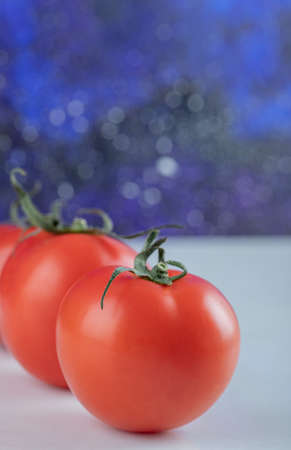 Red fresh tomatoes on a dark backgroundの写真素材