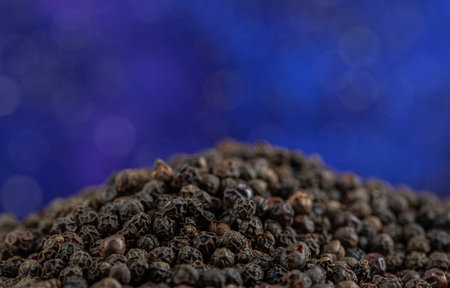 Many of dried peppercorns on a blue backgroundの写真素材