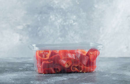 Slices of sweet red peppers on a plastic plateの写真素材