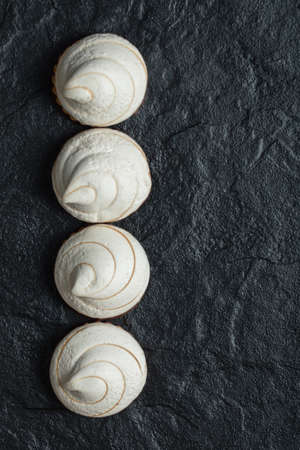 A line of delicious cupcakes on a dark backgroundの写真素材