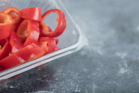 Slices of sweet red peppers on a plastic plateの写真素材