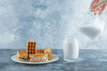 Delicious fresh waffles with glass cup of milkの写真素材