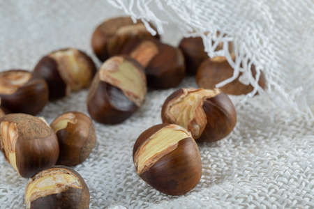 Delicious healthy chestnuts on a white sackclothの写真素材