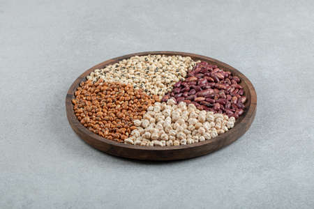 Plate of various dry pea and beans on marble surface. High quality photo