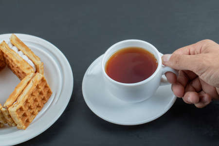 A cup of aroma tea with delicious waffles. High quality photoの写真素材