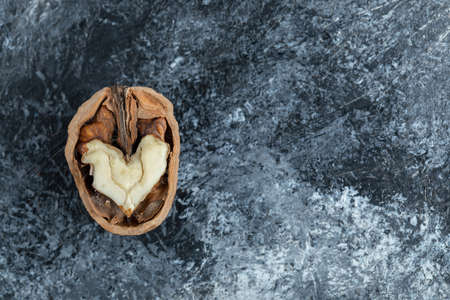 Cracked walnut isolated on the gray backgroundの写真素材