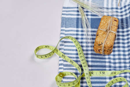 Biscuits and tape measure on a white background with tableclothの写真素材
