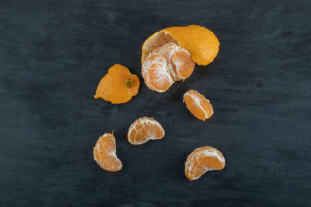 Slices of sour tangerine on a dark backgroundの写真素材
