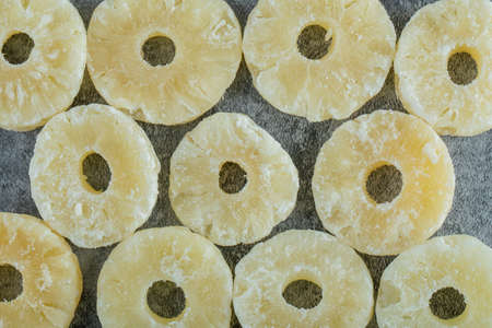 Dried pineapple slices on a gray backgroundの写真素材