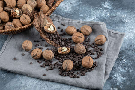 Healthy walnuts with aroma coffee beans on a gray tablecloth
