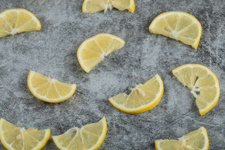 Slices of sour lemon on a gray backgroundの写真素材