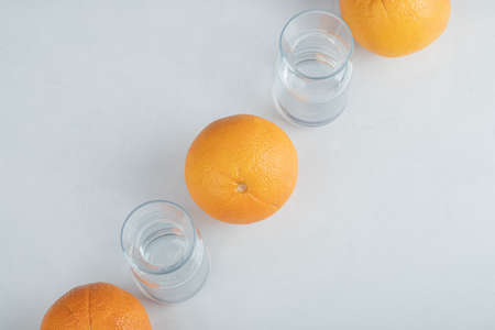 Fresh orange fruits with empty glass pitchersの写真素材