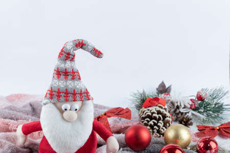 Santa figurine and festive baubles on white backgroundの写真素材