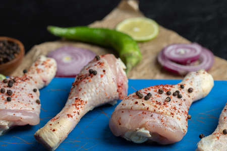Close up view raw chicken drumstick and vegetablesの写真素材
