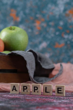Juicy apples in a rustic wooden boxの写真素材