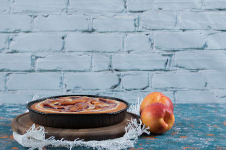 Strawberry pie served with red and yellow peachesの写真素材