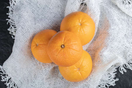 Fresh orange fruits isolated on a white sackclothの写真素材