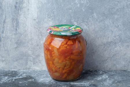 A glass jar with mixed vegetables on marble backgroundの写真素材