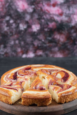A slice of strawberry pie on a wooden board