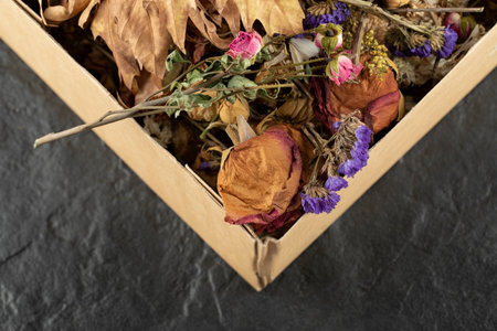 Dried roses flowers with dried leaves in a paper boxの写真素材