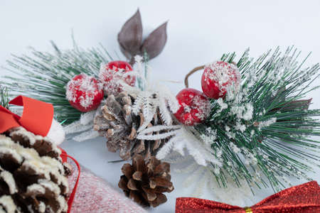 Christmas pinecone with pine leaves on white background