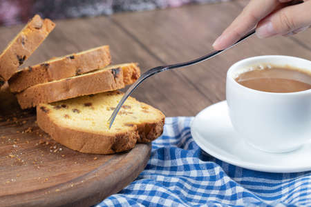 Sliced sultana pie served with a cup of coffee