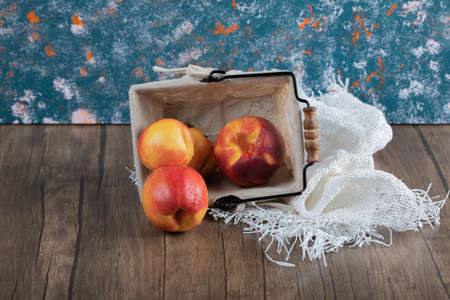 Apples in a mini metallic basket with a towel insideの写真素材