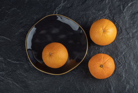 Fresh orange fruits isolated on a black background