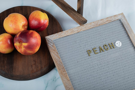 Yellow red peaches on a wooden board