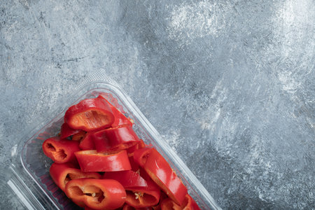 Sliced red peppers in plastic container