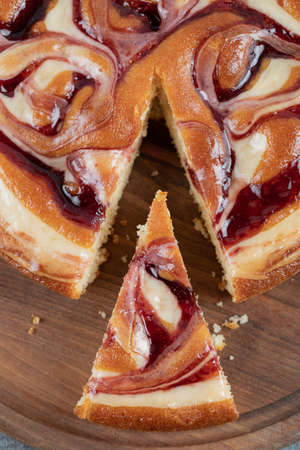 Taking a slice of strawberry pie on a wooden board