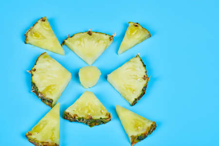 Slices of pineapple on blue backgroundの写真素材
