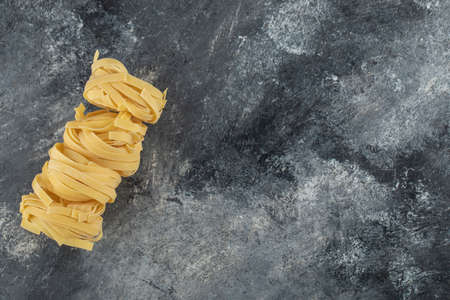 Raw dry nest noodles on a marble backgroundの写真素材