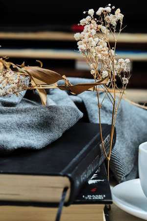 Two black notebooks under blue cloth with flower