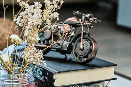 A tiny bicycle with flowers on the blue backgroundの写真素材