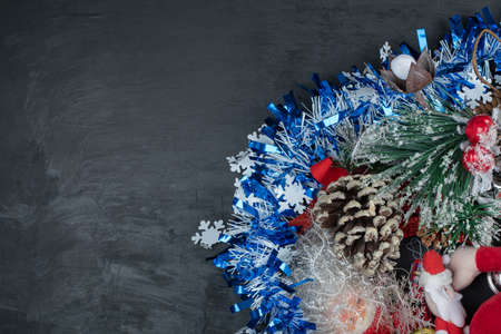 Christmas tinsel and ornaments on dark backgroundの写真素材