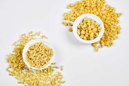Various uncooked pasta bowls on white backgroundの写真素材