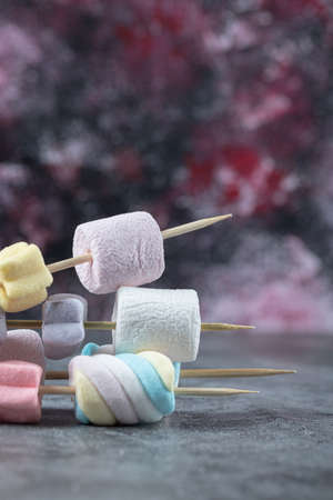 Colorful marshmallows on the sticks to be grilledの写真素材