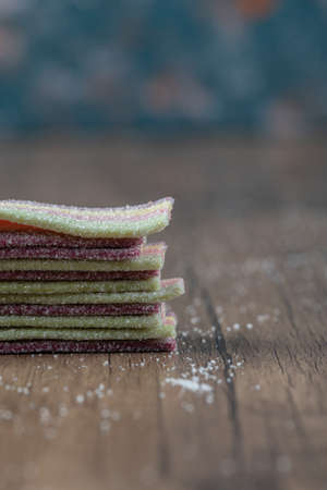 Long narrow rainbow jellybeans on a wooden boardの写真素材