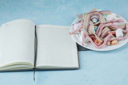 Marshmallow and jellybeans with a blank cookbook aside
