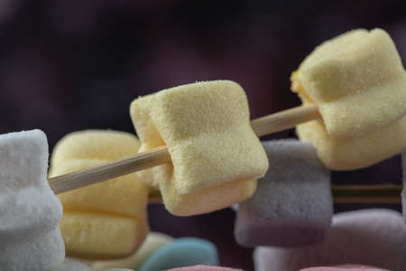 Colorful marshmallows on the sticks to be grilledの写真素材