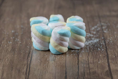 Soft spiral shape yummy marshmallows on the wooden boardの写真素材