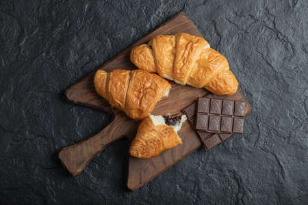Croissants with chocolate filling on a wooden boardの写真素材