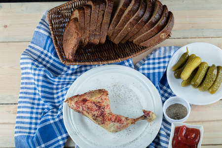 A white plate with fried chicken and slices of breadの写真素材