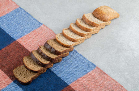 Bunch of rye bread slices on tablecloth